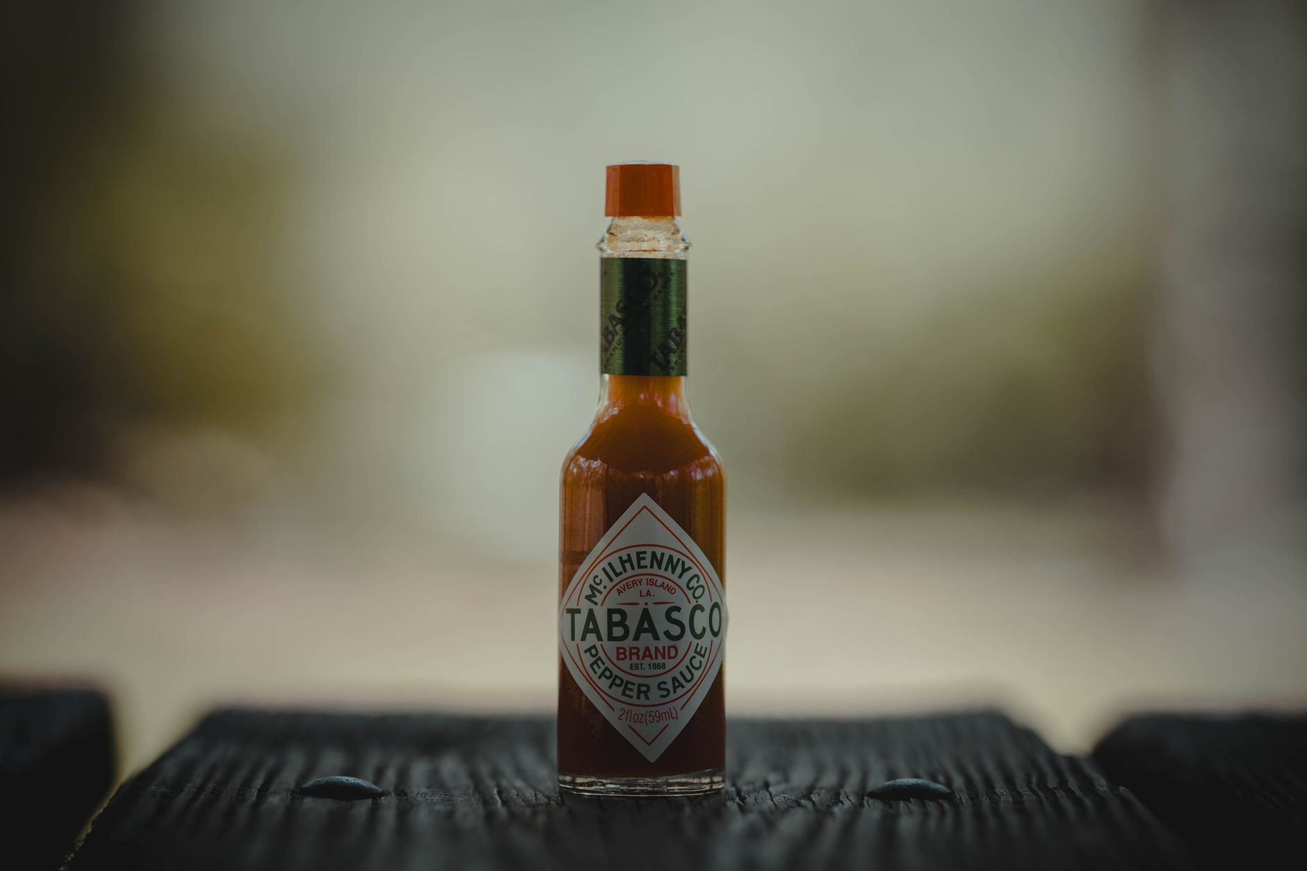 Artisan hot sauce bottle on a warm wooden surface